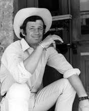 Jean-Paul Belmondo iconic holding bottle of beer seated wearing hat 8x10 photo