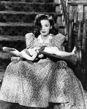 Judy Garland sits on stairs holding statue The Harvey Girls 1946 8x10 inch photo