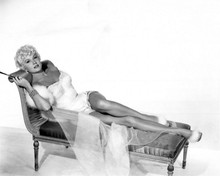 Rhonda Fleming glamour pose lying on sofa showing legs 8x10 inch photo