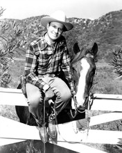 Gene Autry sits on fence with horse Champion at his side 8x10 inch photo