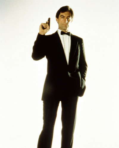 Timothy Dalton suave in tuxedo holds up gun as Bond Living Daylights ...