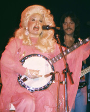 Dolly Parton 1970's seated on stage in pink dress playing banjo 8x10 inch photo