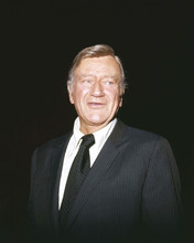 John Wayne The Duke debonair 1970 poses for press in dark suit & tie 8x10 photo