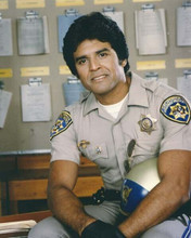 Erik Estrada as John Ponch in uniform sitting in squad room Chips 8x10 photo