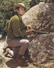 Michael Landon 1960's Bonanza kneeling by rock loading rifle 8x10 inch photo