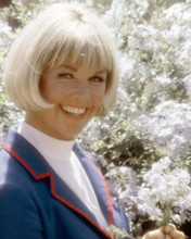 Doris Day with radiant smile posing next to flowering bush 8x10 inch photo