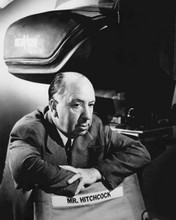 Alfred Hitchcock 1950's posing by camera with his director's chair 8x10 photo