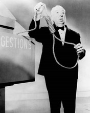 Alfred Hitchcock holds rope at Suggestions box 8x10 inch photo