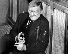 The Shootist 1976 John Wayne gunshot in arm points gun by saloon bar 8x10 photo