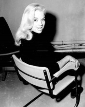 Diana Dors looks over shoulder sitting in chair smiling 1950's era 8x10 photo