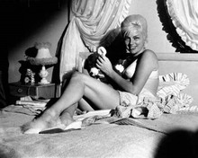 Diana Dors smiling as she sits on bed in bra and panties 1960's 8x10 inch photo