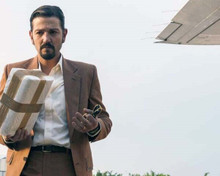 Narcos Mexico Diego Luna as Felix Gallardo in suit by airplane 8x10 inch photo