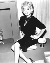 Barbara Nichols 1950's star smiles as she sits by fireplace 8x10 inch photo