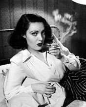 Linda Darnell femme fatale pose smoking cigarette on bed 8x10 inch photo