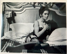 Barbara Steele in black corset & stockings lying on bed 8x10 inch photo