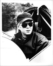 Steve McQueen sits in glider wearing Perols 8x10 photo on fiber paper