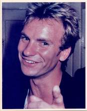 Sting at press conference smiles and points at camera 8x10 inch photo