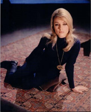 Sharon Tate in purple dress and boots sits on rug 8x10 inch photo