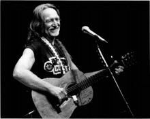 Willie Nelson smiling on stage playing his famous old guitar 8x10 press photo