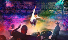 Coldplay live in concert 8x10 inch press photo Chris Martin leaps in air