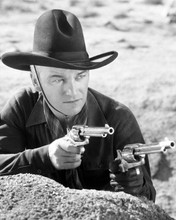 William Boyd as Hopalong Cassidy aims two pistols 8x10 inch photo