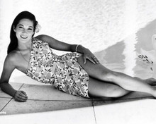 Nancy Kwan smiling in short dress laying poolside 8x10 inch photo