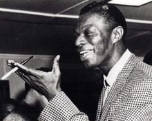 Nat King Cole smiles in checkered jacket holding cigarette 8x10 inch photo