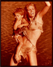 Raquel Welch vintage 8x10 inch photo clutching small child One Million Years BC