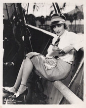 Gloria Swanson seated on boat writng on tablet vintage 8x10 inch photo