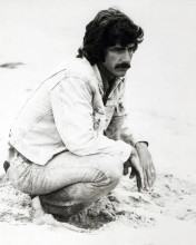 Sam Elliott crouches down on beach in denim jacket 1976 Lifeguard 8x10 photo