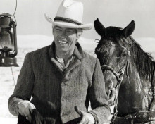 James Coburns flashes his charismatic smile 1975 Bite The Bullet 8x10 inch photo