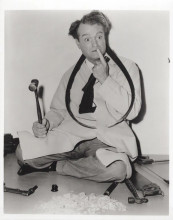 Red Skelton with puzzled look holding hammer vintage 8x10 inch photo