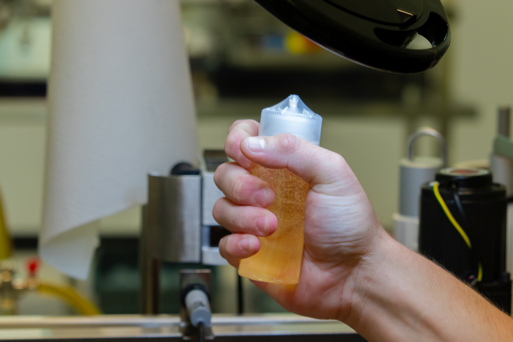 Shaking a vape liquid bottle