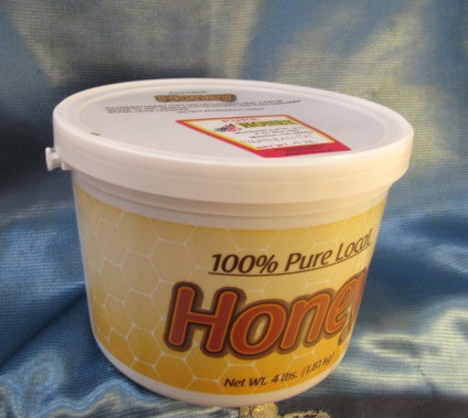 A 4 pound plastic tub of Monastery Honey 