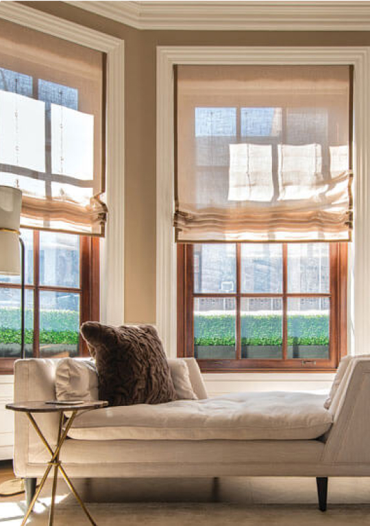 Transparent curtains over a window with a view of the city line