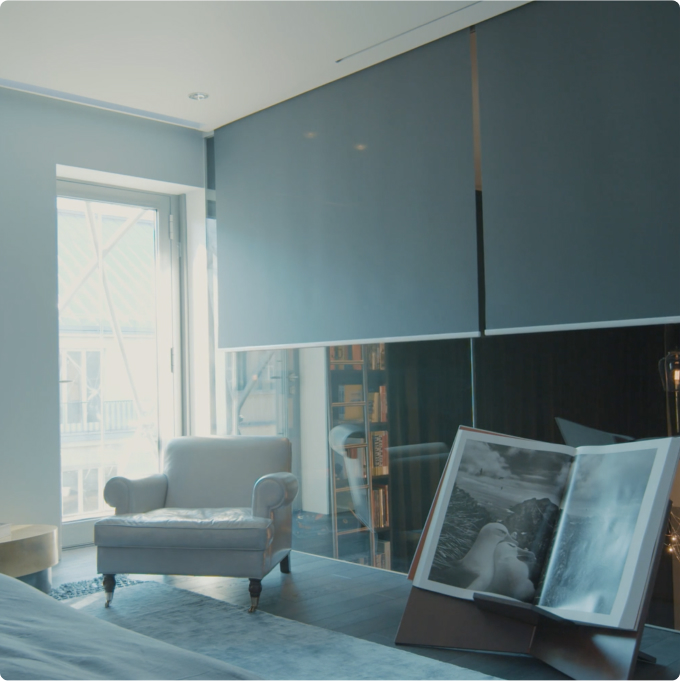 Transparent curtains over a window with a view of the city line