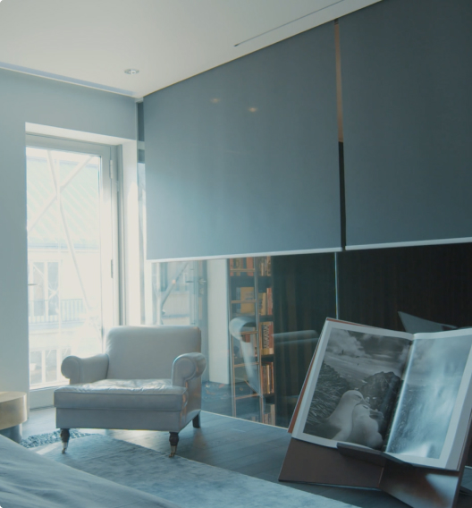 Transparent curtains over a window with a view of the city line