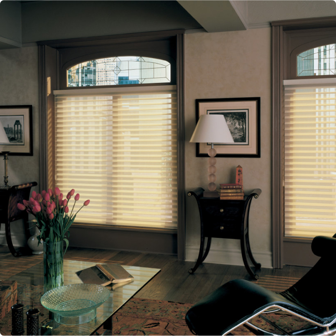 Transparent curtains over a window with a view of the city line