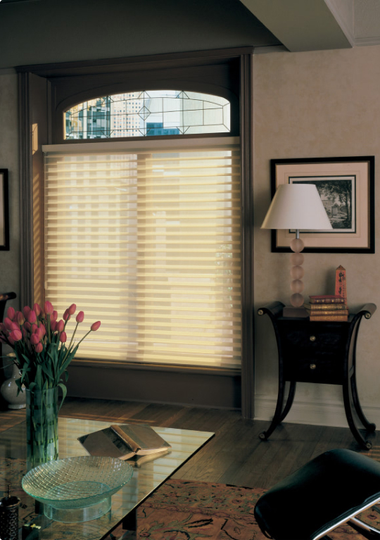 Transparent curtains over a window with a view of the city line
