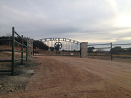 Gate with Rock Columns and Pipe Rail Fence