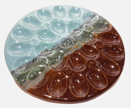 This Deviled Egg Tray in OCEAN TIDE glaze from Clay in Motion holds the whole dozen. Unfortunate for the pre party snackers but a great way to display your perfect egg masterpiece. 
Each porcelain form is hand glazed, so colors and patterns may vary slightly from photos shown. 