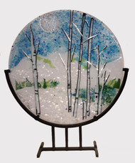The 'Winter Wonder' in a steel stand by Kathi D. Dougherty captures a fine winter day in the mountains. This 16" fused glass round rests in a black coated steel stand for displaying.

Shop now or call to speak with a sales associate for additional assistance. 
Earthwood Collections, 970.577.8100