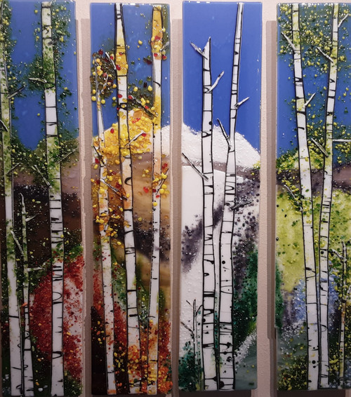 Four Seasons - 4 piece set by Kathi Dougherty portrays all the seasons in individual panels to create a dramatic scene in fused glass. 