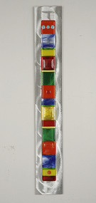 Wall Totem in Spectrum by Hands On Art Glass. 2"x24", fused glass on aluminum. Please call our galleries to see which pieces are currently on hand. 