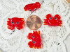 These little red crabs measure about 20x35x8mm with 1mm vertical beading holes