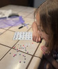 Searching for letters on the ABC Card - getting ready to make her bracelet
