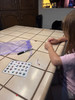 Making her ABC bracelet - pulling letters from the card