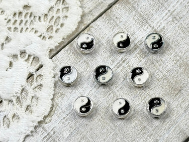 Tiny treasures of black & white enamel surrounded by silver plating