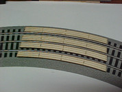36" Curved crossing for Lionel Fastrack Sectional Track.  Makes One (1) two (2) lane automobile crossing for road across track.
See other listing for special Auto Ramps for this crossing.  Smooths the transition for cars to cross tracks.