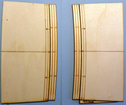 This photo illustrates the product offered. A pair of roadway ramps to raise a roadway surface to the track elevation for the crossing.
Lionel FasTrak has a molded ballast section that elevates the rails, the ramps ease this transition for the roadway.
